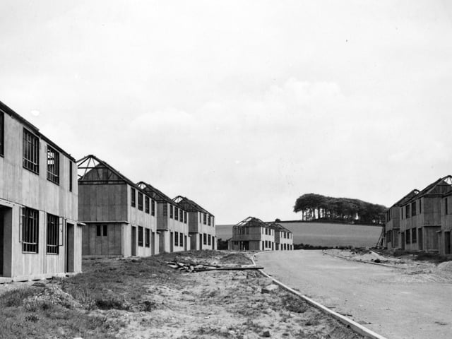 A street of houses nearing completion on the Moortown housing estate in May 1949 with King Alfred's Castle in the distance.