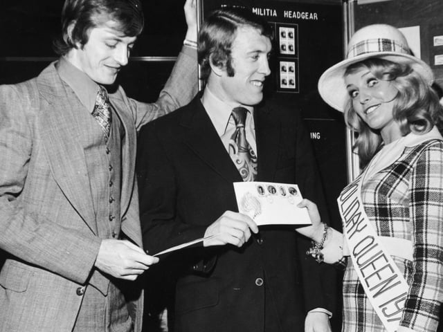 Leeds Uniteds stars Allan Clarke (left) and Mick Jones are pictured with Jersey Holiday Queen Gaynor Lacey at a Holiday Exhibition held at your YEP's Wellingston Street headquarters in November 1972.