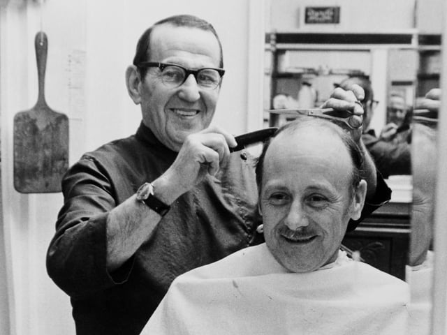 This is Street Lane barber Barney Siddal pictured in November 1972. He is with customer of 18 years Leslie Harris.
