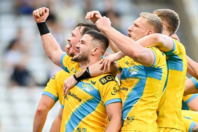 James Bentley, left, celebrates with his Leeds Rhinos team-mates after scoring a try against Castleford Tigers at Magic Weekend. Picture: Will Palmer/SWpix.com.