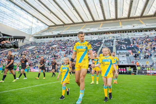 Rob Burrow's daughters Maya and Macy walk out with Ash Handley prior to their game against Castleford at Magic Weekend (Picture: Allan McKenzie/SWPix.com)