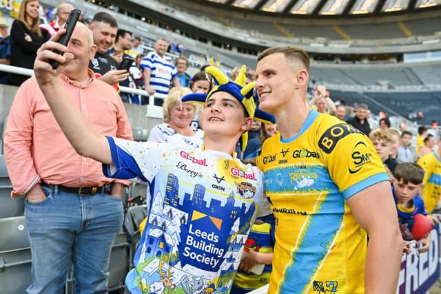 ALL SMILES: Ash Handley of Leeds Rhinos poses for a photo with a fan after the game against Castleford Tigers Picture by Will Palmer/SWpix.com
