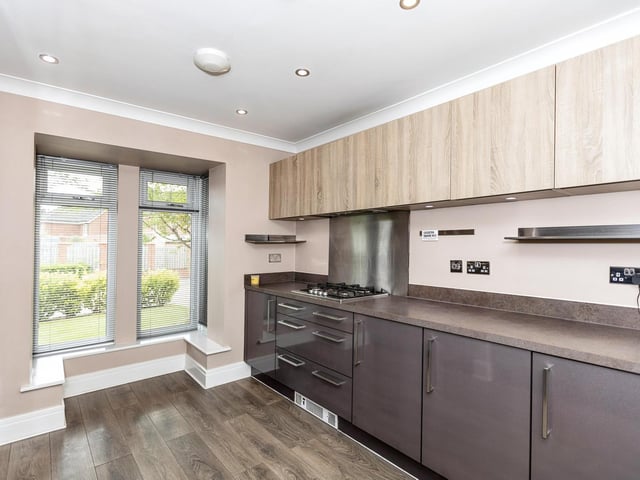 The ground floor is made up of a generous entrance hall, an open plan living area with a bay window looking out to the cul-de-sac, a large dining area and a cosy seating area, all enhanced by wooden continuous flooring and bi-fold doors opening to the patio.