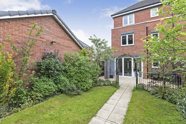 A private rear garden is set in a gorgeous woodland with a lawn, patio and a pizza oven all included.