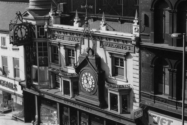 The Time Ball Buildings on Lower Briggate. The premises were home to John Dyson & Sons, watchmakers, repairers, and jewellers, founded in 1865. On the front of the buildings are two clocks, one of which bears the words 'John Dyson 25 & 26', with the Time Ball above. The ball would drop daily at exactly 1pm Greenwich Mean Time, until the practice stopped in 1924.