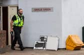 An officer leaving Saville Green flats, where the toddler died after falling from a window (Photo: SWNS)
