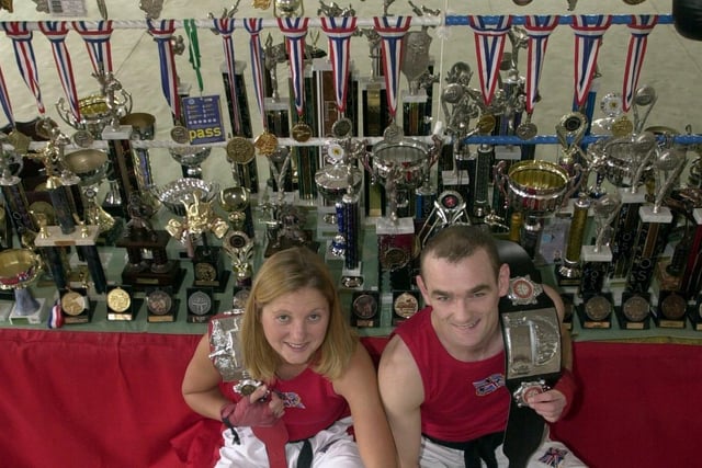 This is Lisa Reynolds and Paul Lynch of Aegis Kick Boxing Club at the National Martial Arts College at Armley with some of their trophies.