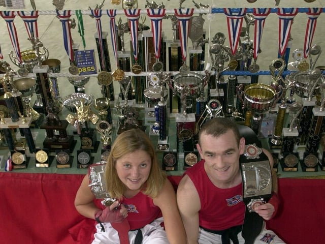 This is Lisa Reynolds and Paul Lynch of Aegis Kick Boxing Club at the National Martial Arts College at Armley with some of their trophies.