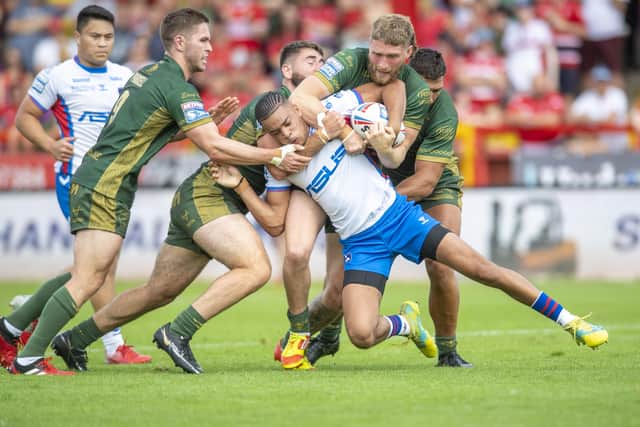 BLOCKED: Hull KR's players pounce on Wakefield's Lewis Murphy. Picture: Tony Johnson