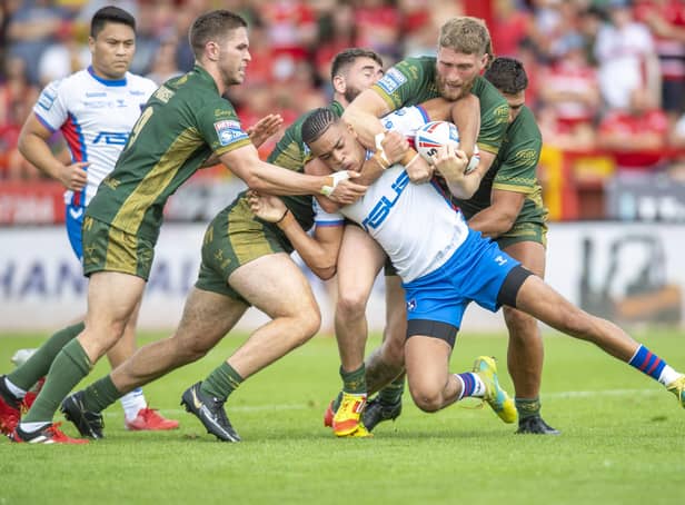 BLOCKED: Hull KR's players pounce on Wakefield's Lewis Murphy. Picture: Tony Johnson
