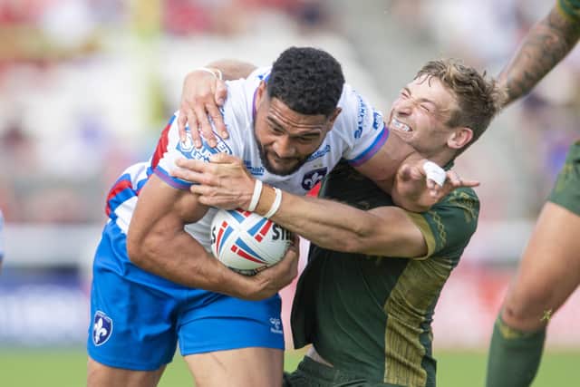 COME HERE: Hull KR's Jimmy Keinhorst brings Wakefield's Kelepi Tanginoa to ground. Picture: Tony Johnson