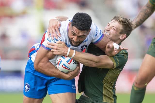 COME HERE: Hull KR's Jimmy Keinhorst brings Wakefield's Kelepi Tanginoa to ground.   Picture: Tony Johnson