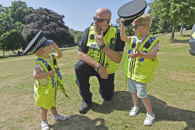 PCSO Phil Cannon of Stainbeck Police Station has fun with brothers Isaac Storey, two and Noah, four, from Wakefield.