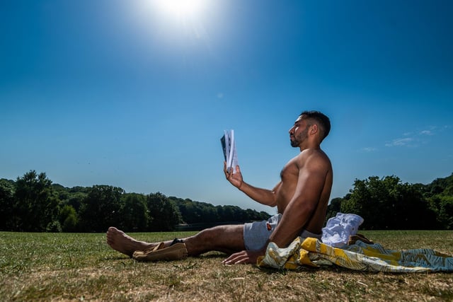 Mahammed Miah, of Leeds, enjoying the warm weather whilst reading in Roundhay Park.