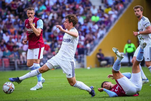 QUICKLY SETTLED: Leeds United new boy Brenden Aaronson, left, looks to start another charge after tangling with Aston Villa's Philippe Coutinho, right, in Sunday's clash in Brisbane. Photo by PATRICK HAMILTON/AFP /AFP via Getty Images.