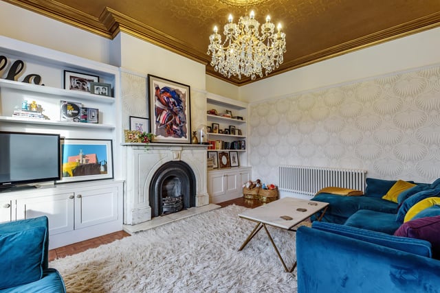 There is also a separate spacious lounge that boasts a marble fireplace with storage and shelving built into the chimney breast recesses.