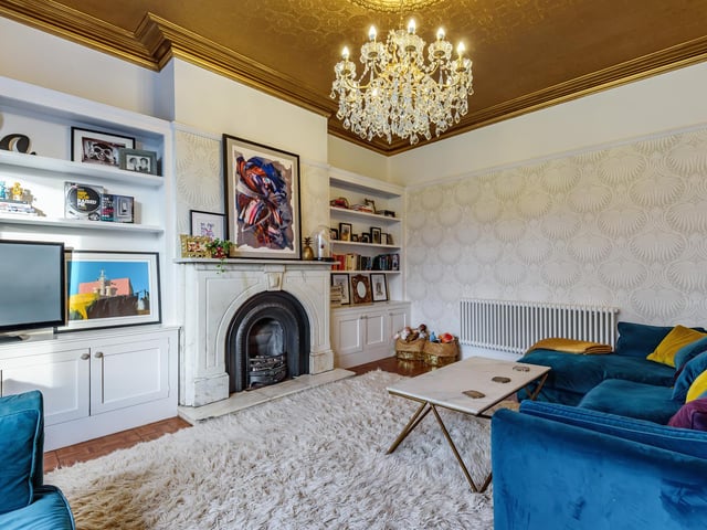 There is also a separate spacious lounge that boasts a marble fireplace with storage and shelving built into the chimney breast recesses.