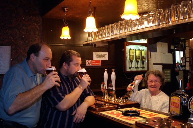 Betty Sharp, pulls a pint at the Grey Goose pub watched by barman Mick Auty (left) (barman) and landlord Carl Ward in November 1995.