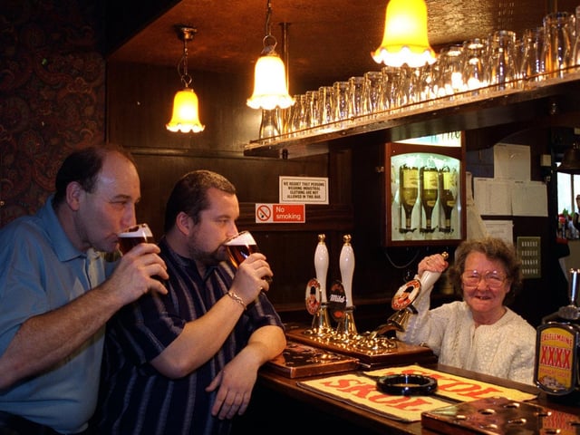 Betty Sharp pulls a pint at the Grey Goose pub watched by barman Mick Auty, left, and landlord Carl Ward in November 1995.