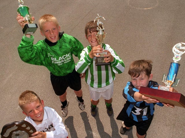 Members of the four triumphant football teams at Clapgate Primary in July 1996. Pictured, back from left, are Scott Murgatroyd (U-8s), Dane Waugh (U-11s), Karl Featherstone (U-9s), and Danny Needham (U-10s).