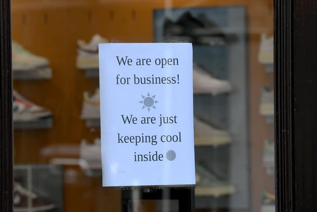 Pictured is a sign displayed in a shop window earlier today as temperatures rose.