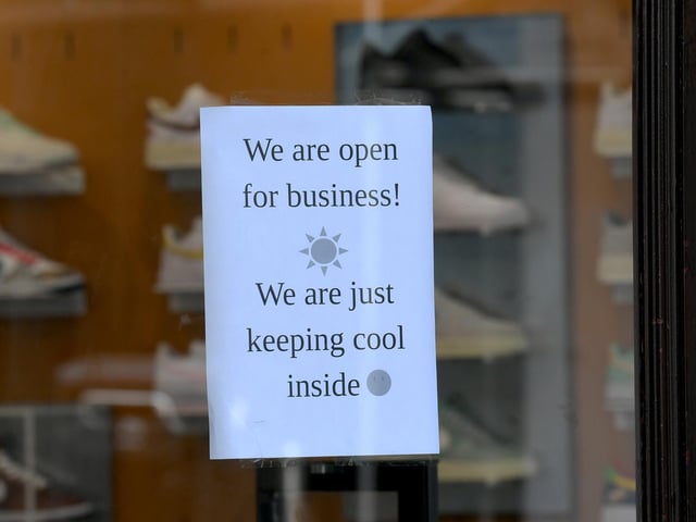 Pictured is a sign displayed in a shop window earlier today as temperatures rose.