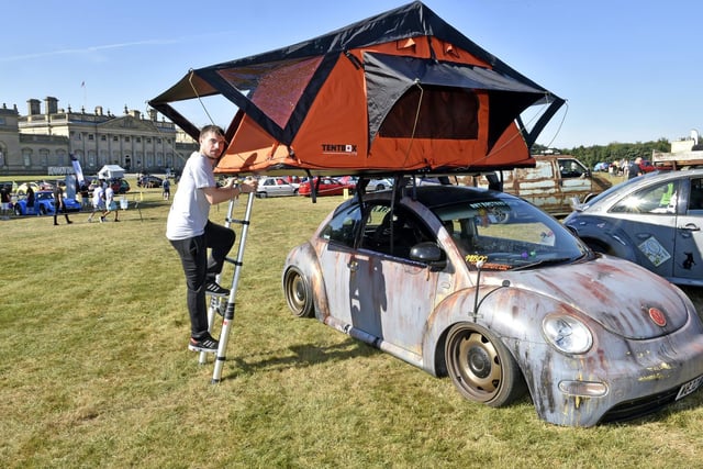 Andrew Brown sleeps in a tent above his Beetle