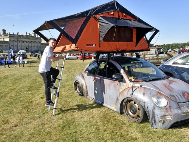 Andrew Brown sleeps in a tent above his Beetle