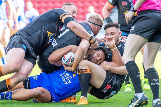 NEAR MISS: Leeds Rhinos' Rhyse Martin is held up by Castleford's Liam Watts, Oliver Holmes and Niall Evalds. Picture: Allan McKenzie/SWpix.com.