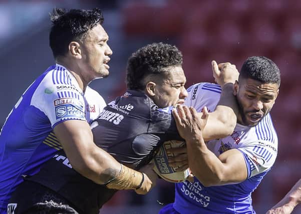BIG HITTER: Castleford's Derrell Olpherts is tackled by Leeds Rhinos' Zane Tetevano, left, and Kruise Leeming. Picture: Allan McKenzie/SWpix.com.