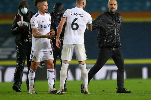 WE'LL MEET AGAIN: Leeds United captain Liam Cooper, centre, shakes hands with Manchester City boss Pep Guardiola, right, after October's 1-1 draw at Elland Road. Photo by Catherine Ivill/Getty Images.