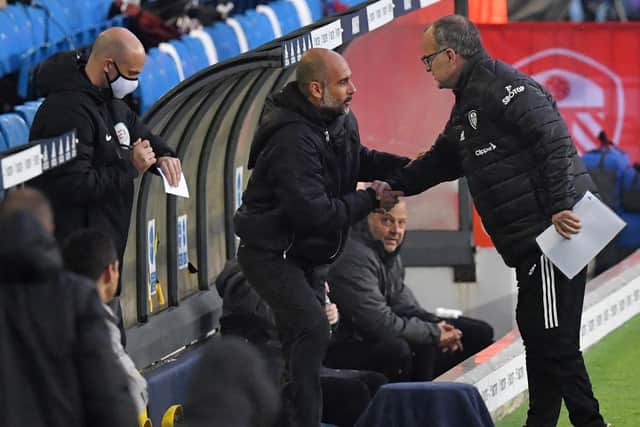 MEETING OF MINDS: Leeds United head coach Marcelo Bielsa, right, greets Manchester City boss Pep Guardiola, centre, before October's clash at Elland Road. Photo by PAUL ELLIS/POOL/AFP via Getty Images.