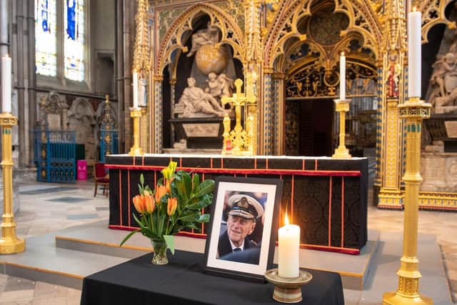 A photograph of the Duke of Edinburgh is displayed alongside the nave at Westminster Abbey, London, which has been dressed in black to mark his death (Photo: Dominic Lipinski/PA Wire)