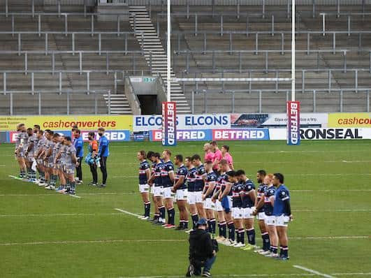 The sides stand for a minute's silence in memory of the Duke of Edinburgh before Catalans' Cup win over Trinity. Picture by SWpix.com