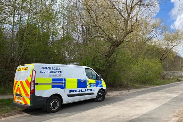 Crime Scene Investigators on Redcote Lane, Leeds, where a man's body was found