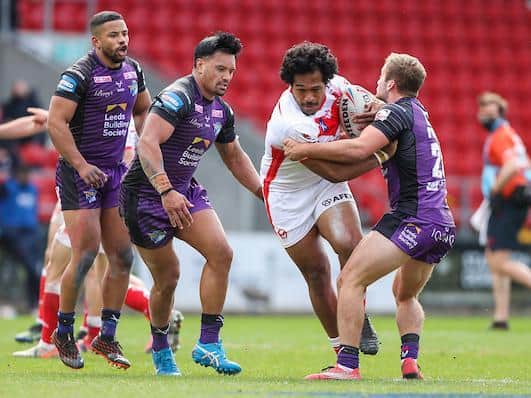 Rhinos' Jarrod O'Connor makes a tackle on Saints Agnatius Paasi. Picture by Alex Whitehead/SWpix.com.
