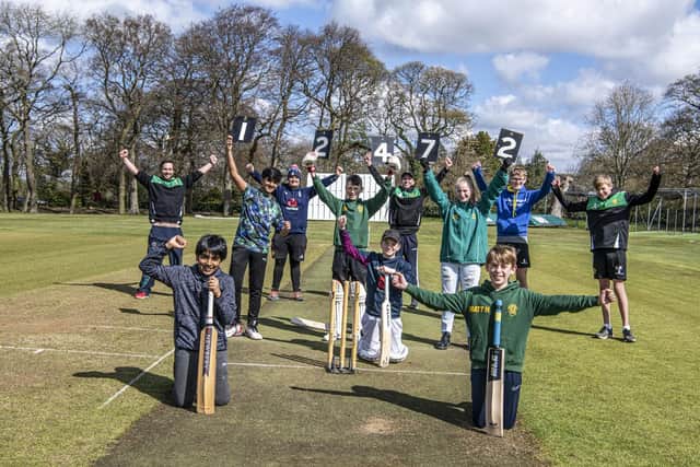 Adel Cricket Club juniors celebrate their challenge of 12,472 runs between the stumps