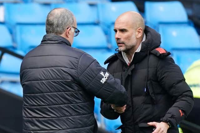 PRAISE: From Manchester City boss Pep Guardiola, right, pictured embracing Leeds United head coach Marcelo Bielsa after Saturday's clash at the Etihad. Photo by TIM KEETON/POOL/AFP via Getty Images.
