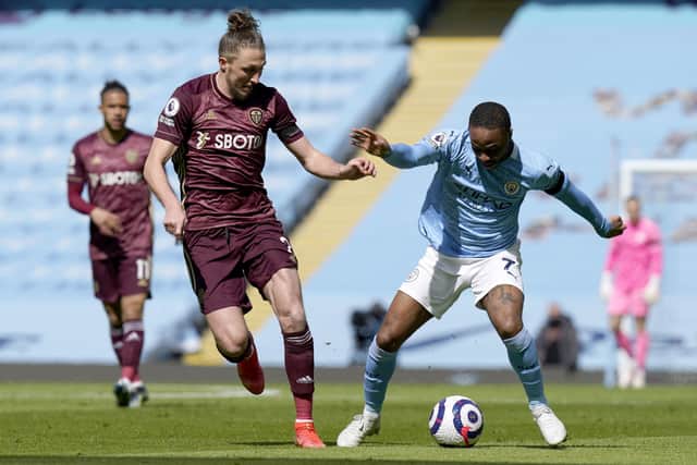 EYE ON THE BALL: Leeds United's Luke Ayling (left) and Manchester City's Raheem Sterling battle for the ball during the Premier League match at the Etihad Stadium. Picture: Tim Keeton/PA Wire.
