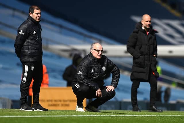 MASTER MIND: Leeds United manager Marcelo Bielsa crouches on the sidelines with Manchester City boss Pep Guardiola in the background. Picture: Michael Regan/PA Wire.