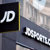 Retailer JD Sports Fashion has posted falling annual profits, but said earnings are set to bounce back strongly over the year ahead