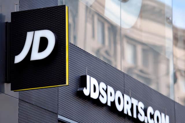 Retailer JD Sports Fashion has posted falling annual profits, but said earnings are set to bounce back strongly over the year ahead