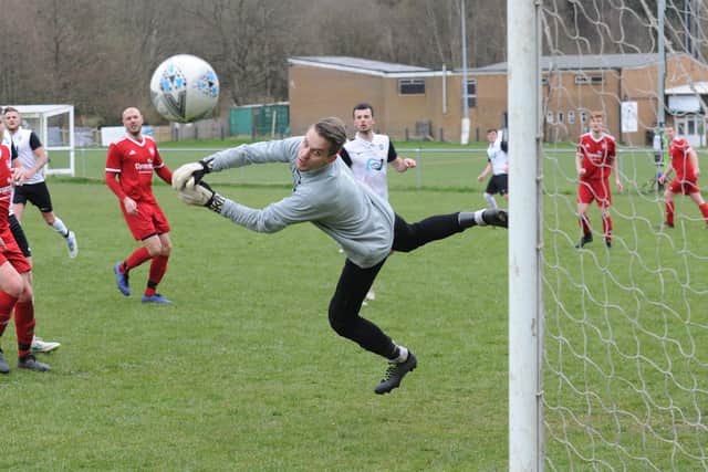 Alwoodley goalkeeper, Doman Rodwski, gets his hand to the ball to deny visitors Littletown a second goal. Picture: Steve Riding.
