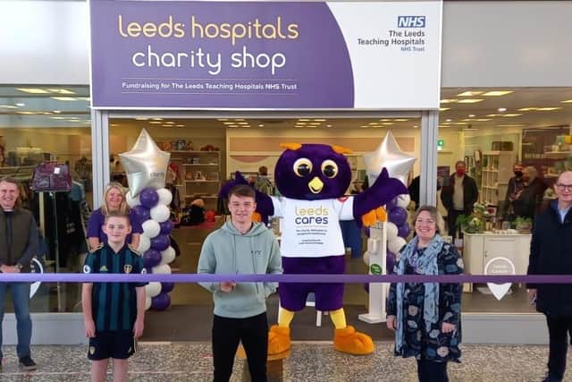 Joining the opening celebrations are from left to right: Dean Hoyle, Trustee, Leeds Hospitals Charity; Joanne Wrigg, volunteer, Crossgates Charity Shop; Rhys Pearson, nine-year-old football fan; Jamie Shackleton, LUFC player; Ernie, Leeds Hospitals Charity mascot; Thadra Bryant, retail manager, Crossgates Charity shop; Dr Edward Ziff OBE DL Hon DBA, Chair of the Board of Trustees, Leeds Hospitals Charity.