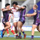 HARD GRAFT: St Helens' Agnatius Paasi is tackled by Leeds Rhinos' Zane Tetevano, Kruise Leeming and Matt Prior. Picture: Mike Egerton/PA Wire.
