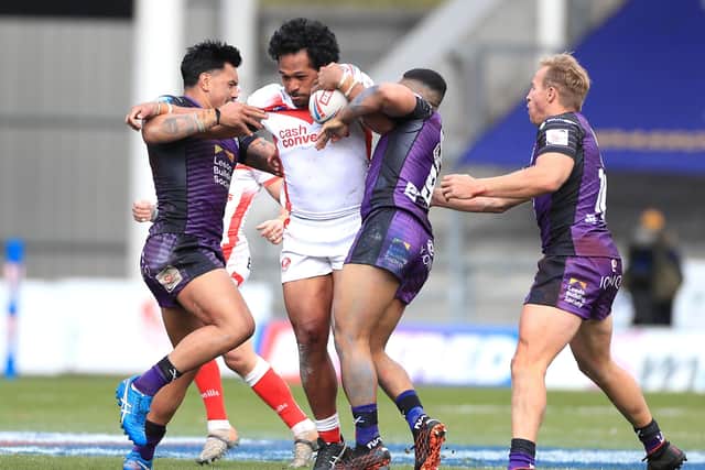HARD GRAFT: St Helens' Agnatius Paasi is tackled by Leeds Rhinos' Zane Tetevano, Kruise Leeming and Matt Prior. Picture: Mike Egerton/PA Wire.