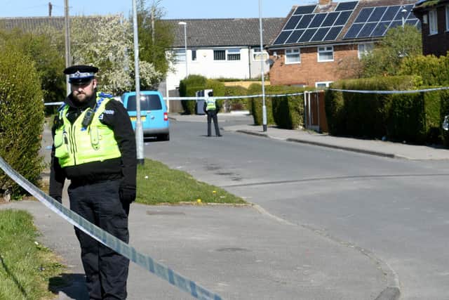 Police guard a cordon in Stanks Parade, Swarcliffe (photo: Gary Longbottom).