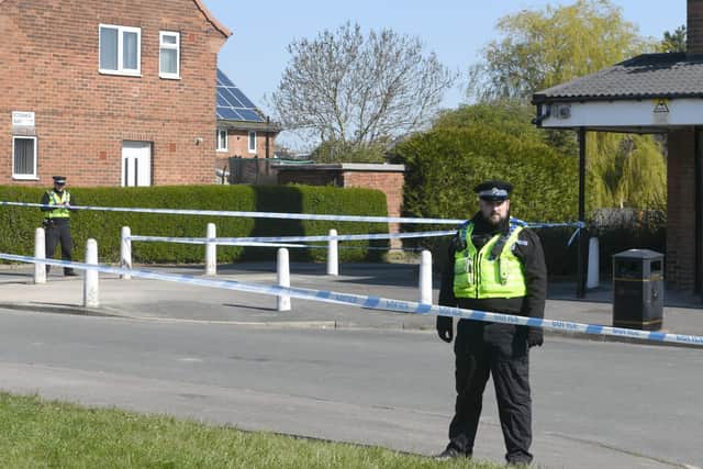 Police guard a cordon in Stanks Parade, Swarcliffe (photo: Gary Longbottom).