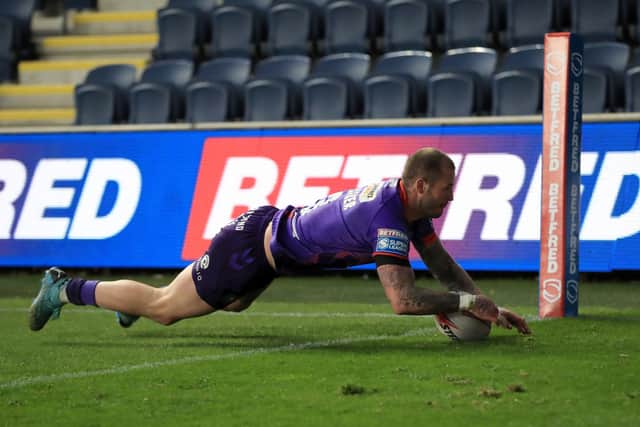 Wigan Warriors' Zak Hardaker scores their side's second try of the game during the Betfred Super League match at Emerald Headingley Stadium, Leeds. Picture date: Thursday April 15, 2021. PA Photo. See PA story RUGBYL Leeds. Photo credit should read: Mike Egerton/PA Wire. 

Use subject to restrictions. Editorial use only, no commercial use without prior consent from rights holder.