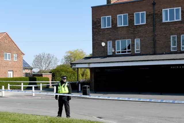 Police guard a cordon in Stanks Parade, Swarcliffe, after the attack